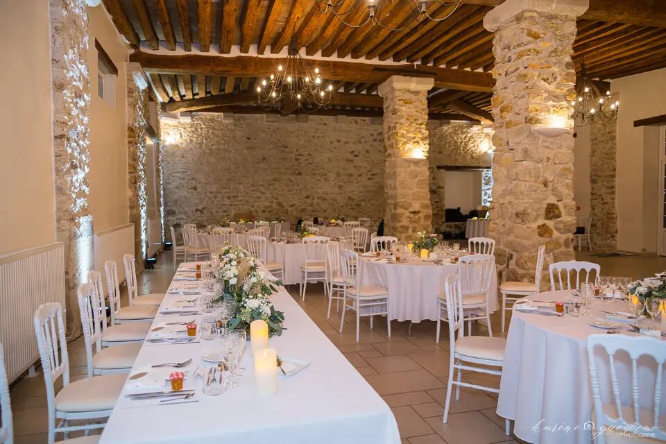Organisation de table pour un mariage dans une bâtisse en pierre blanche
